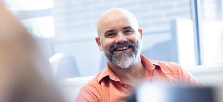 Smiling graduate student with beard