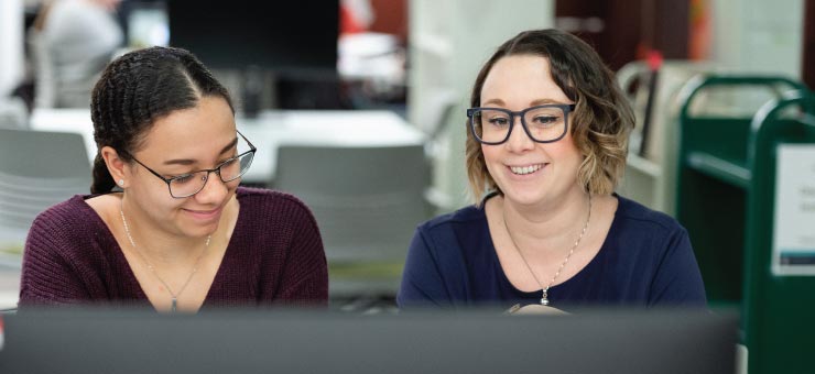 Librarian helping student