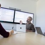 Three people viewing a data presentation