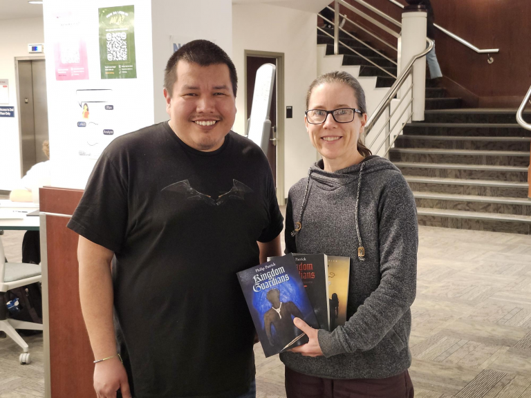 Author Phil Patrick and LSA Karin Haug holding Phil's books
