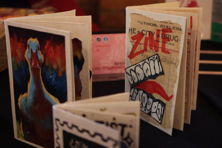 Close up of three zines one with a duck on it
